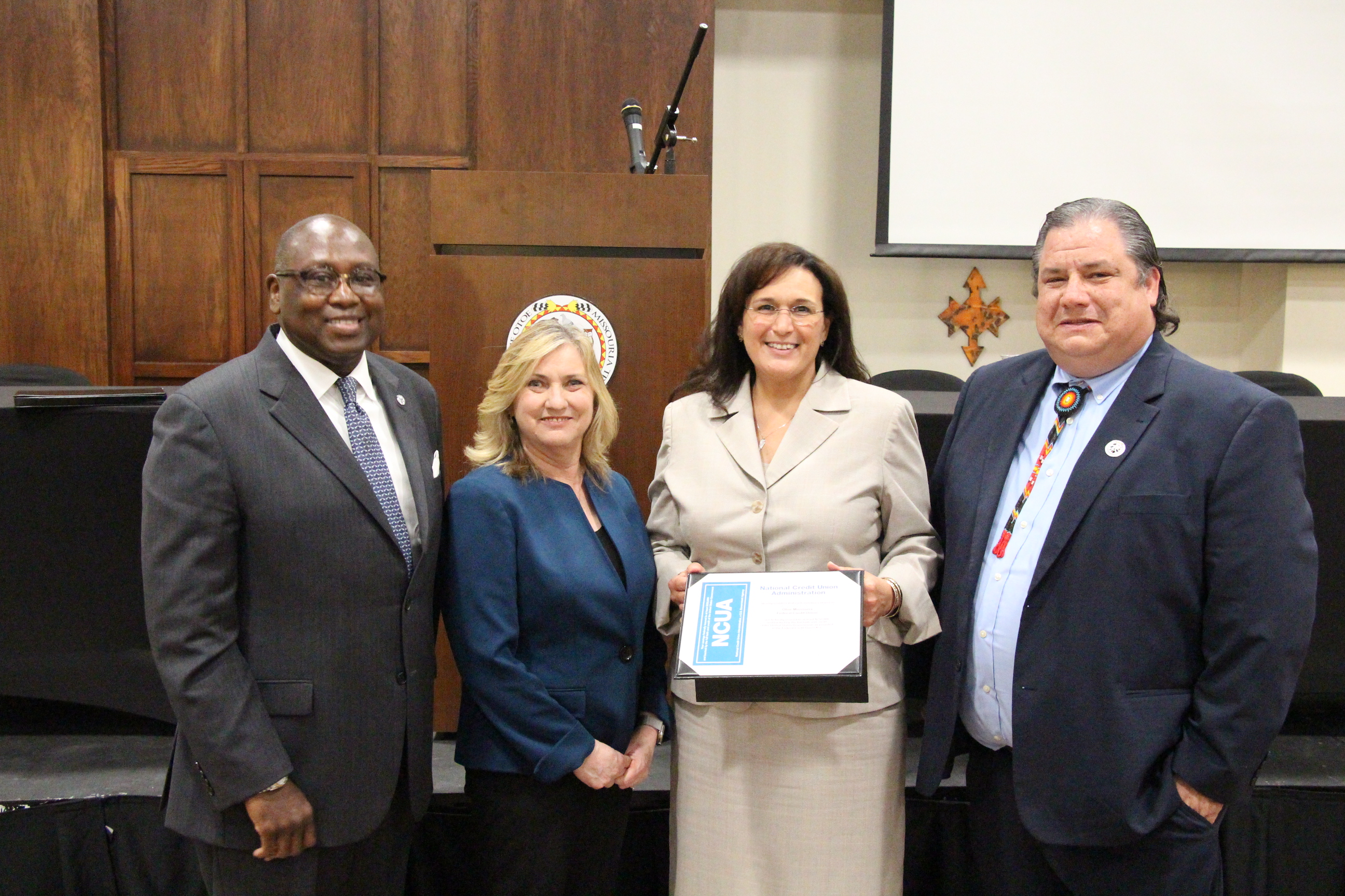 052119_Leaguer_NCUA Chair_presentation Pictured from left are NCUA Chairman Rodney Hood, Cornerstone’s Operations & Engagement Vice President Lorri Gaither, Otoe-Missouria FCU President & CEO Leilani Harpole, and Tribal Council and OMFCU Chairman John Shotton