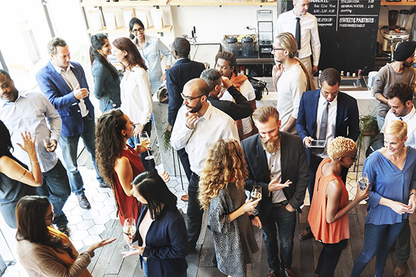 Group of people milling about and talking, photo from above